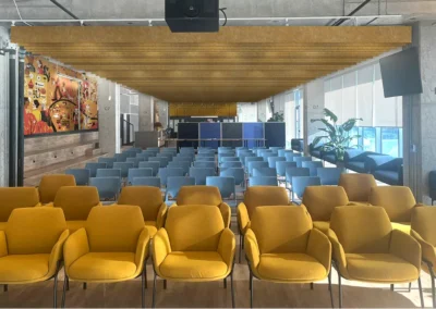 Atrium Acoustic Optimization The open atrium with exposed concrete ceilings was reimagined to address acoustic challenges. Wall-mounted felt panels and sculpted ceiling baffles were integrated as both functional and aesthetic elements, shaping a quieter and more engaging space.